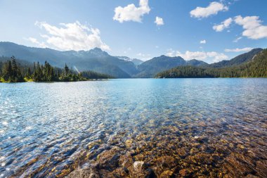 Kanada 'daki dağ gölünün sakin sularındaki kayaların yansımasıyla sakin bir manzara..