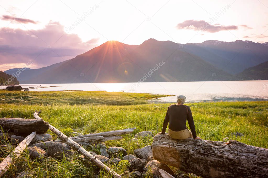 Tourist in Pacific ocean coast in British Columbia, Canada. Wanderlust travel concept.