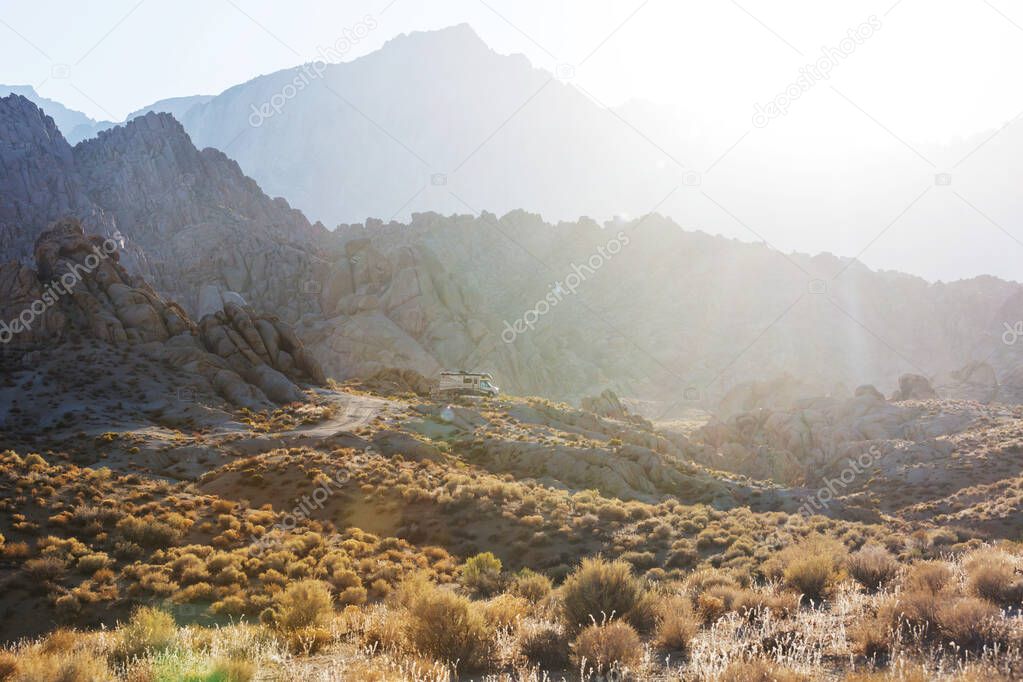 Hiker in unusual stone formations in Alabama hills, California, USA