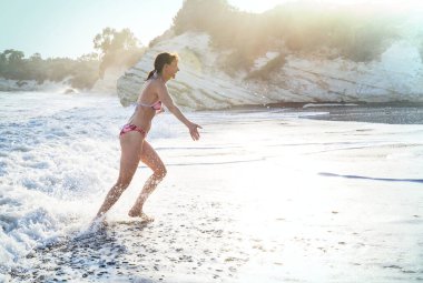 Kız deniz dalgasında zıplıyor