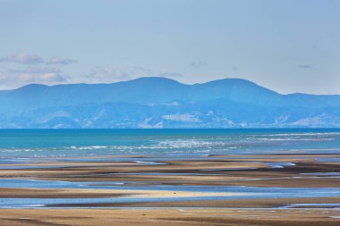 Ocean Beach, Yeni Zelanda 'da güzel bir gün batımı. İlham verici doğal ve seyahat geçmişi