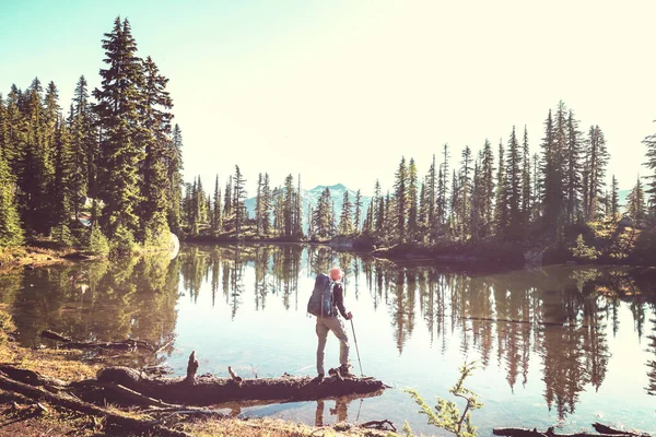 A man is resting at ease by the calm lake. Relaxation vacation