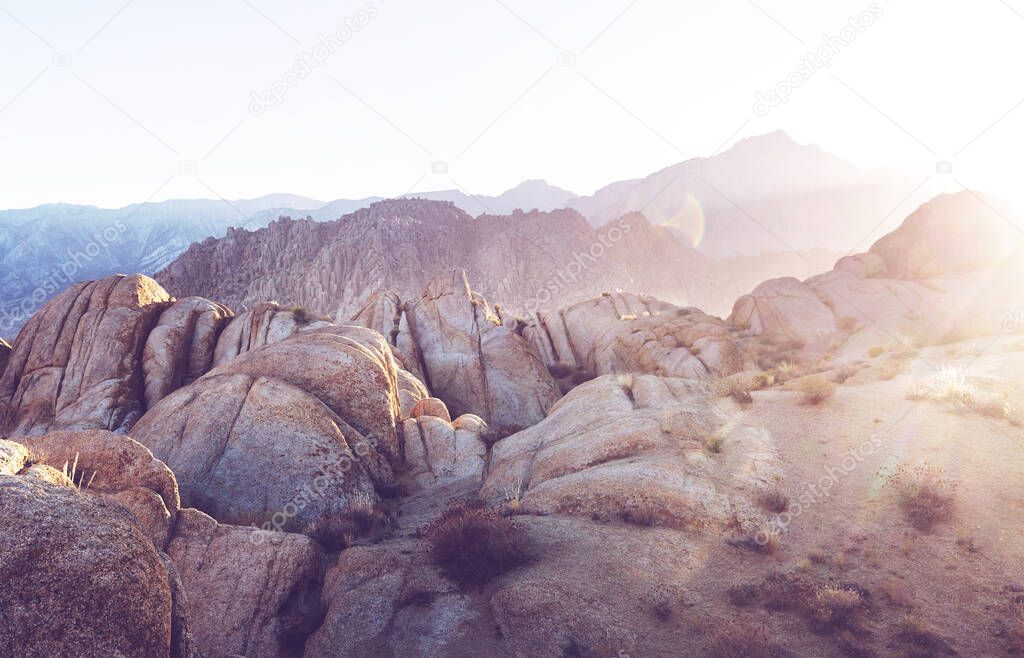 Hiker in unusual stone formations in Alabama hills, California, USA