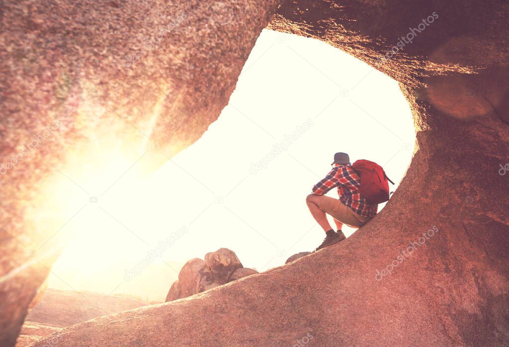 Hiker in unusual stone formations in Alabama hills, California, USA