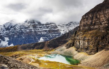 Kanada 'daki dağ gölünün sakin sularındaki kayaların yansımasıyla sakin bir manzara..