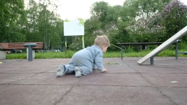 Adorable funny baby play at playground under care of his hipster parents — Stock Video