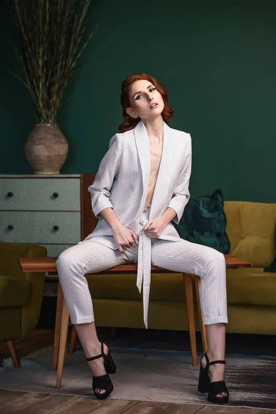 Pretty redhead thin young woman in white unbuttoned pant suit — Stock Photo, Image