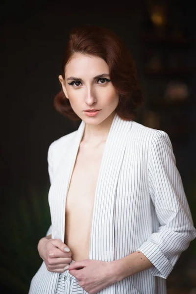 Pretty redhead thin young woman in white unbuttoned pant suit — Stock Photo, Image