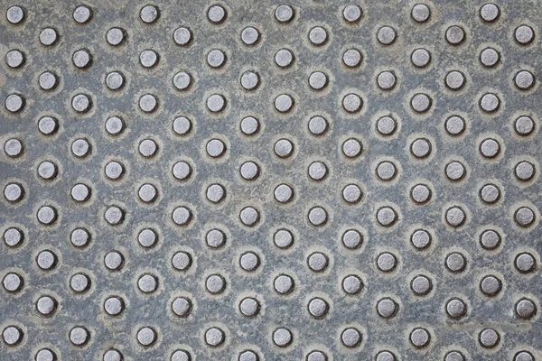 Metallic texture belonging to some street furniture. Worn metal texture with detail. Metal stamping texture. grey metal Background. Seamless pattern for construction, building material design.