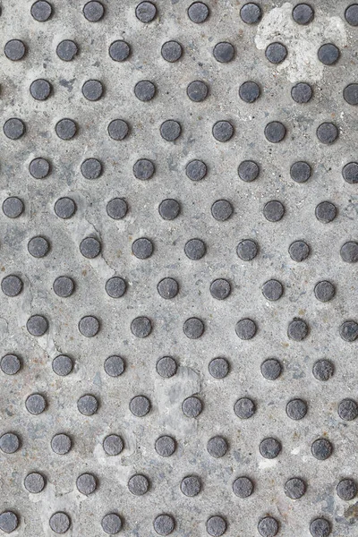 Metallic texture belonging to some street furniture. Worn metal texture with detail. Metal stamping texture. grey metal Background. Seamless pattern for construction, building material design.