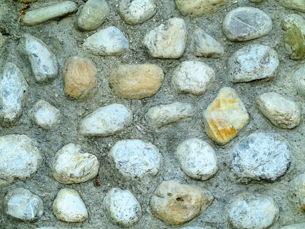 Achtergrond textuur van oude ronde grijze stenen muur — Stockfoto