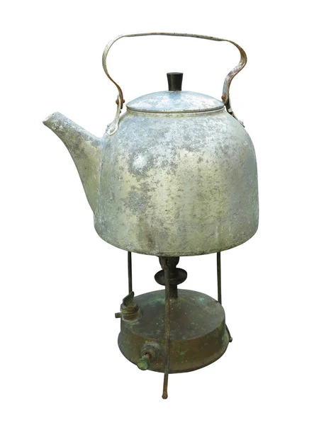 Old dirty kettle teapot on a kerosene burner over white Stock Photo