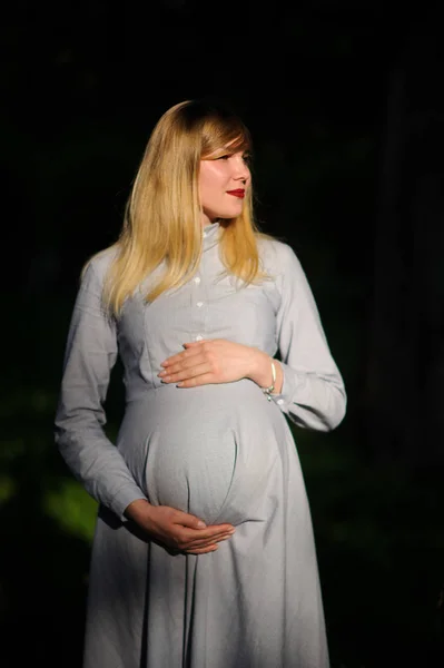 С беременной женщиной на открытом воздухе — стоковое фото
