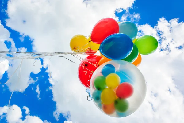 Bright colorful balloons over blue sky background — Stock Photo, Image
