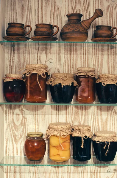 Jars with jam on the kitchen shelves — Stock Photo, Image