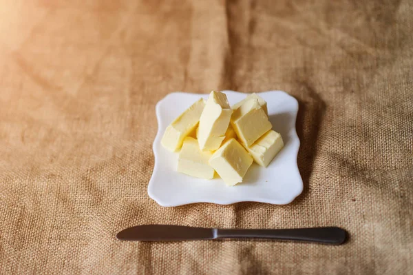 Piece of butter on a desk — Stock Photo, Image