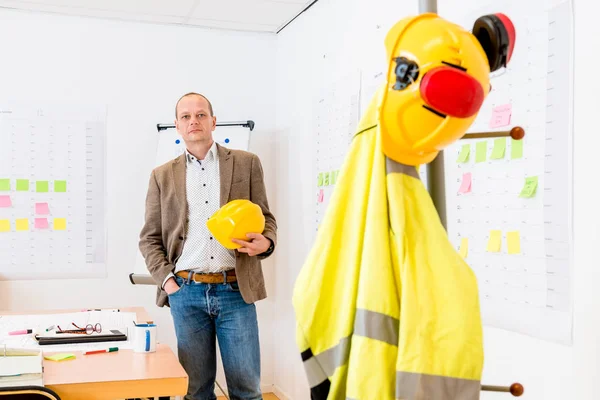 Portrait Mature Architect Holding Hardhat While Standing Hand Pocket Office Stock Photo