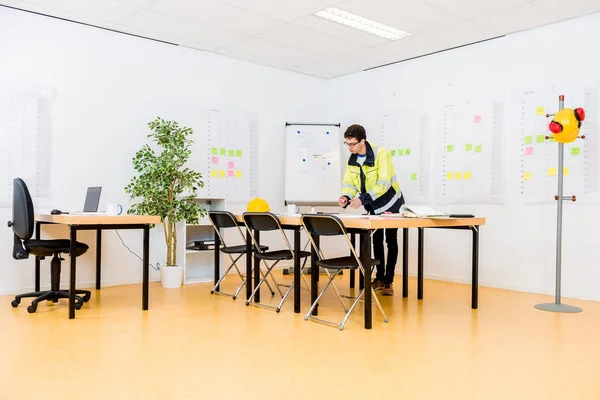 Full Length Architect Wearing Reflective Clothing While Working Table Workplace — Stock Photo, Image