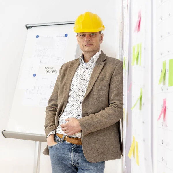 Senior Engineer Wearing Hard Hat Leaning Wall Several Planning Boards Royalty Free Stock Images