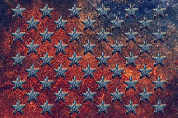 Embossed USA flag star shapes on rusty metal surface, worn metallic texture as background