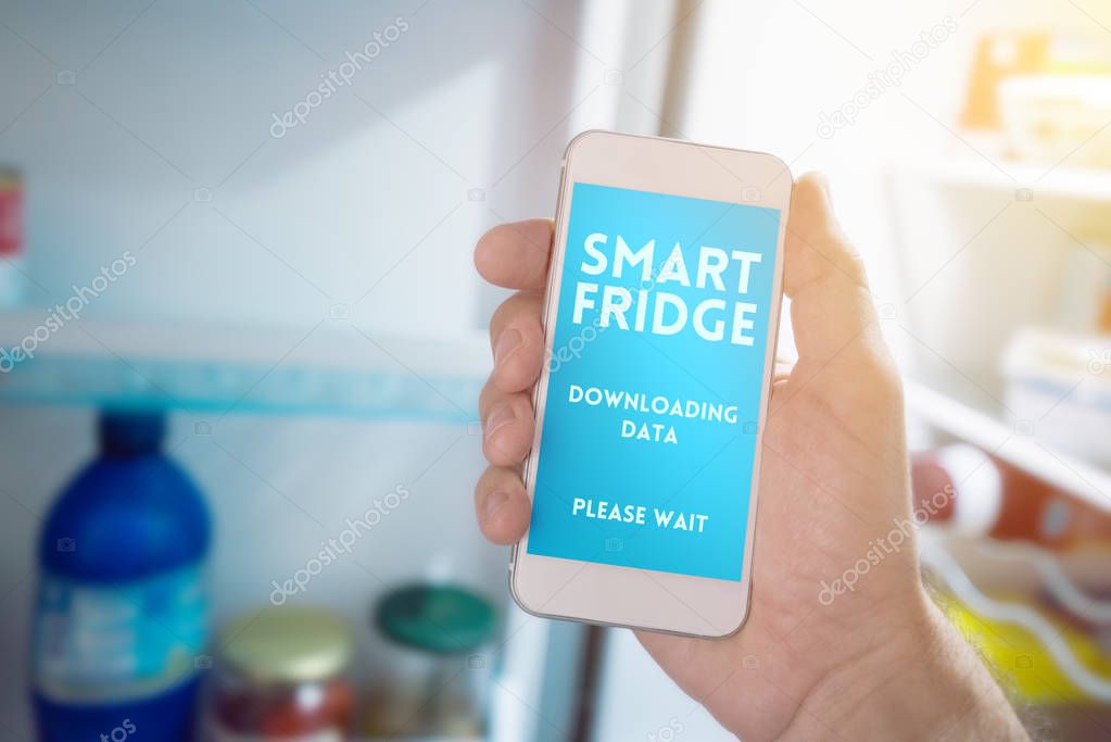 Internet of things, smartphone connecting with refrigerator to generate smart shopping list. Home kitchen appliance connecting with mobile phone and exchanging data.