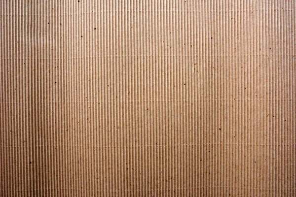 Corrugated cardboard paper material texture background, rough and weathered grungy backdrop