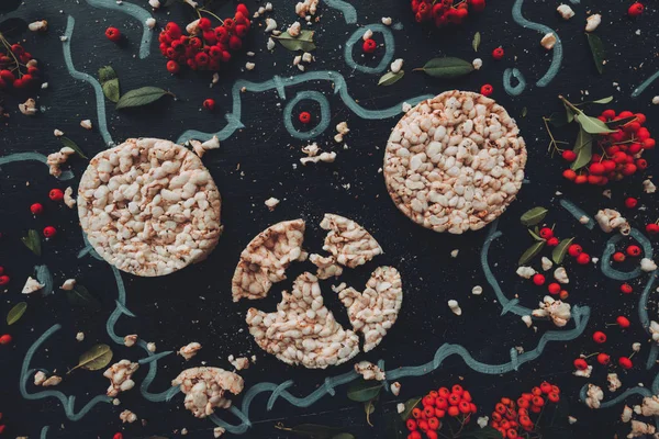 Flach Lag Knusprige Reiskuchen Auf Dunklem Holzhintergrund Mit Floralem Arrangement — Stockfoto