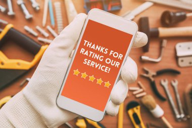 Thanks for rating our service message on smartphone screen in male hand. Customer service survey feedback concept. clipart