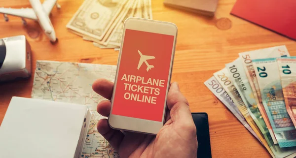 Airplane tickets online mobile app. Man holding smartphone with mock up application screen related to holiday vacation journey trip.