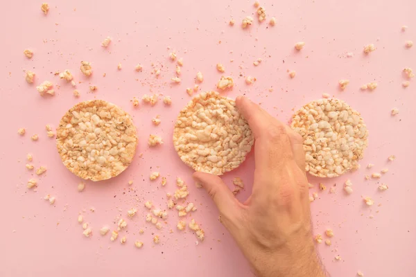 Rice Cakes Male Hand Pastel Pink Background Overhead View — Stock Photo, Image