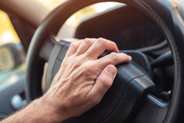 Nervous driver pushing car horn on steering wheel clipart
