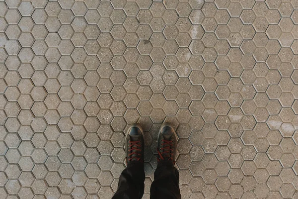 Staande Zeshoekige Beton Bestrating Tegels Achtergrond Voeten Sneakers Van Bovenaf — Stockfoto