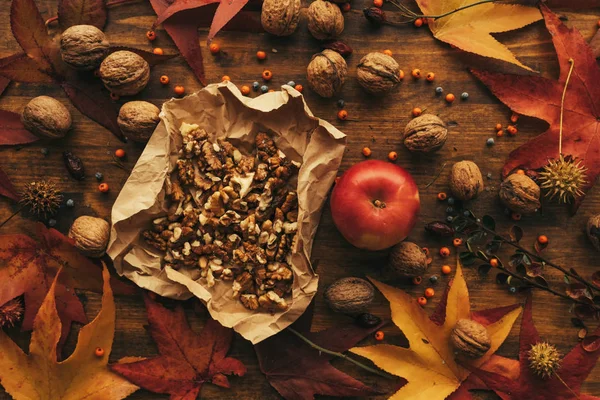 リンゴとクルミ 秋豊富 カラフルなカエデの葉 トップ ビューで飾られた木製のテーブルの上健康的な有機フルーツ — ストック写真