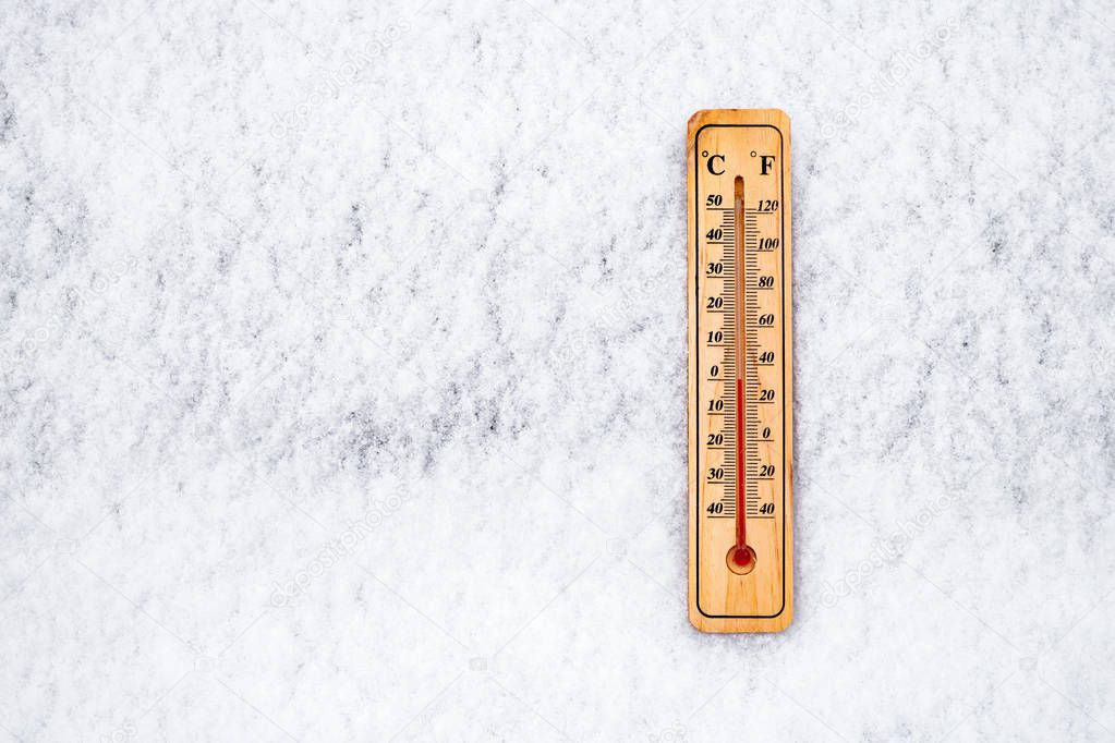 Thermometer in snow at zero degree on Celsius scale