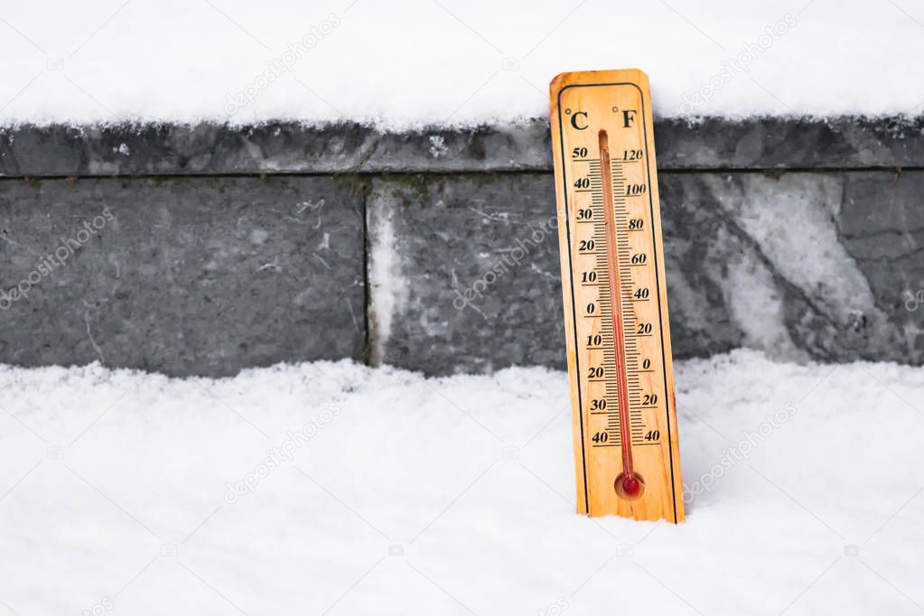 Thermometer in snow at zero degree on Celsius scale