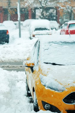 Automobile parking lot with cars covered in snow, parked vehicles in winter season with harsh traffic conditions clipart