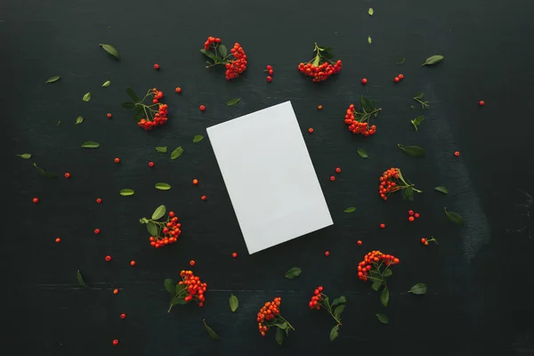 Hardcover book cover design mock up top view overhead shot with floral arrangement, retro toned flat lay minimalism