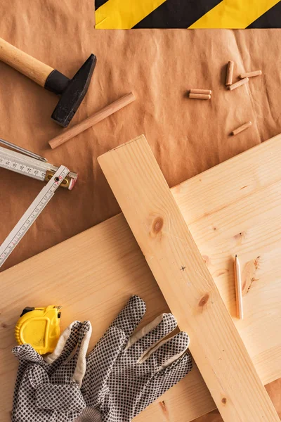 Carpentry woodwork workbench top view with planks and dowels