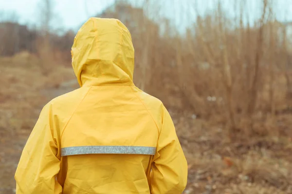 Rear view of woman in raincoat looking into distance — Stock Photo, Image
