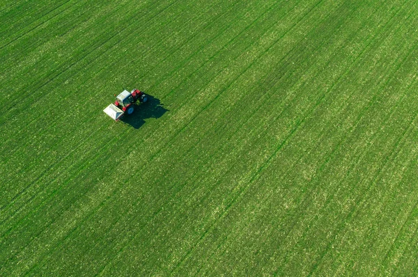 Tracteur agricole fertilisant champ de blé avec NPK — Photo