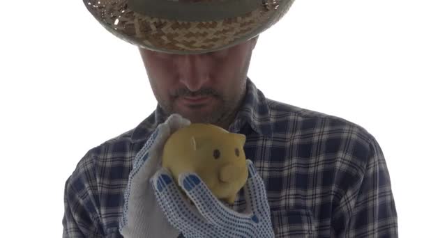 Farmer Cuddles Piggy Coin Bank Footage Male Agronomist Isolated White — Stock Video