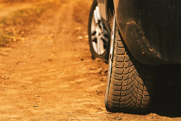 Close up of car tires on dirt country road — Stock Photo, Image