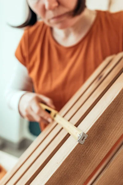 Плотник женского пола, измеряющий деревянный ящик — стоковое фото