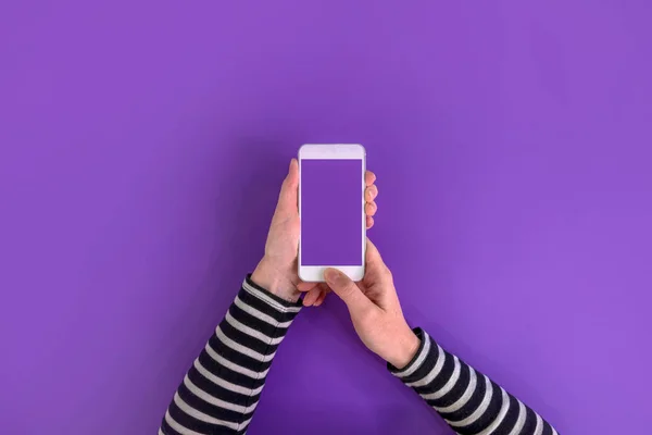 Smartphone in female hands mock up top view