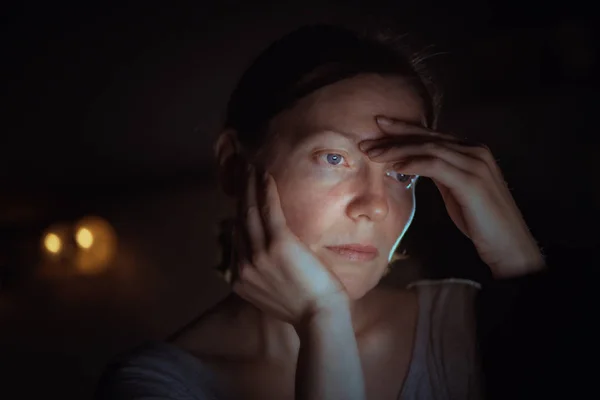 Tired woman working overtime on laptop computer at night — Stock Photo, Image