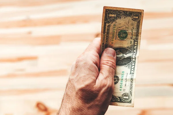 Man paying with one US dollar bill — Stock Photo, Image