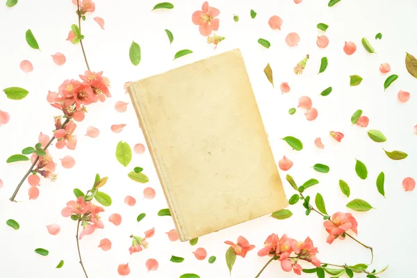Old book mock up with springtime floral decoration