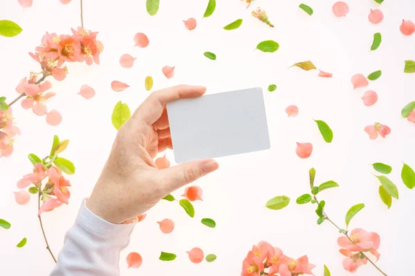 Woman holding blank white business card mock up