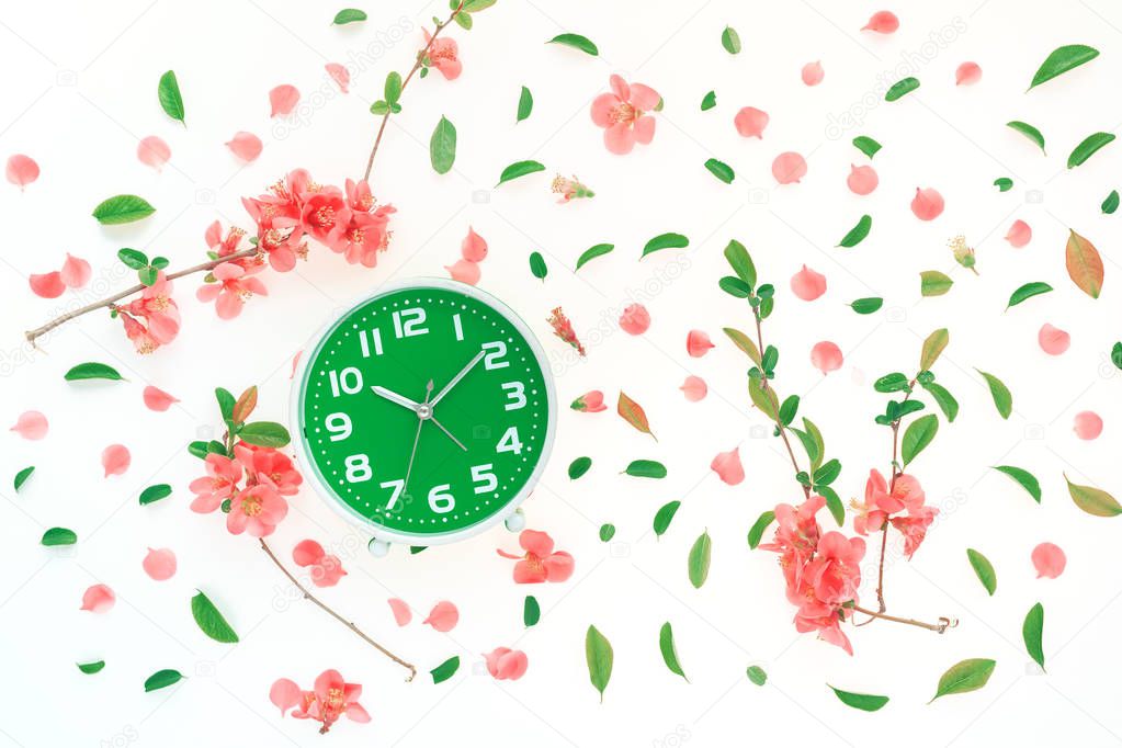 Vintage alarm clock flat lay with colorful springtime decoration