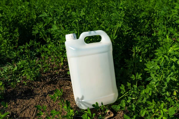 Pesticide jug mock up in clover field